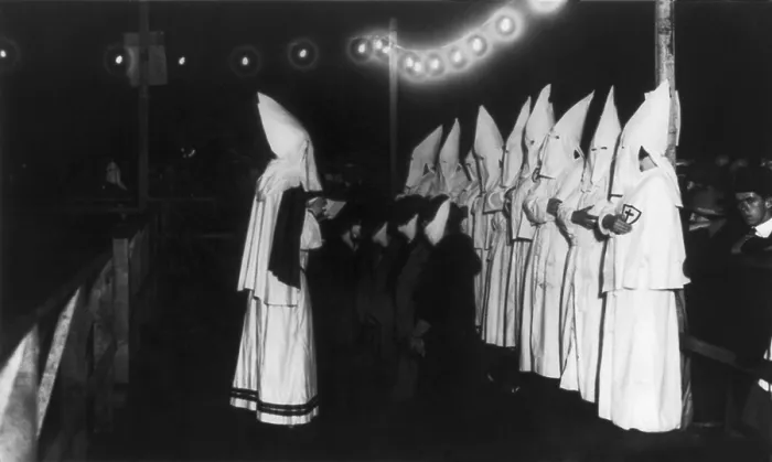 Framed Print : Four masked women kneeling in front of shrouded Klansman reading from a book. The Ku Klux Klan initiation ceremony took place on Long Island, New York in 1924. (BSLOC_2015_16_174) Framed Print : Four masked women kneeling in front of shrouded Klansman reading from a book. The Ku Klux Klan initiation ceremony took place on Long Island, New York in 1924. (BSLOC_2015_16_174)