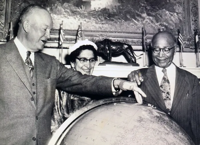 Framed Print : Matthew Henson (1866-1955), African American Arctic explorer, and President Eisenhower discuss the North Pole over a globe at the White House. Mrs. Robert L