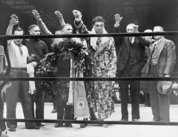 Framed Print : Max Schmeling, with attendants, giving the Nazi salute after his victory over Steve Hamas in Hamburg, Germany, March 10, 1935