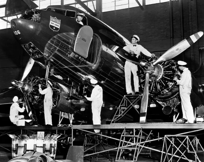Framed Print : Mechanics give a United Airline's Mainliner airplane a routine checkup, 1943. Courtesy: CSU Archives / Everett Collection
