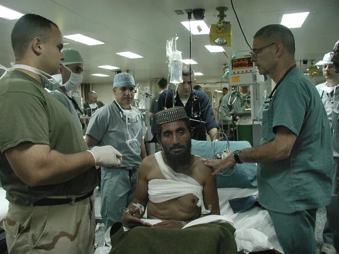 Framed Print : Medical personnel of USS Bataan treat wounded Pashtun soldier from Afghanistan Dec. 6 2001. Photo by:Everett Collection(BSLOC_2011_6_81)