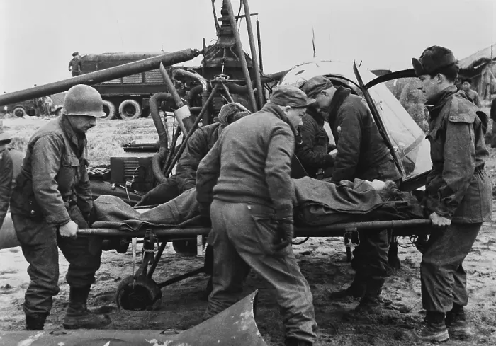 Framed Print : Medics carry a wounded U.S. soldier away from a rescue helicopter