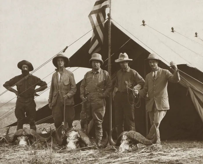 Framed Print : Members of Theodore Roosevelts safari stands behind African buffalo skulls. Standing in front of a tent, L-R: R. J
