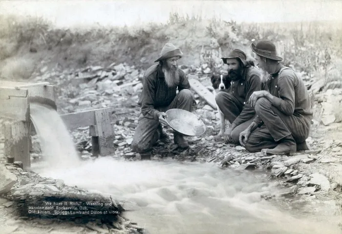 Framed Print : Three men, with dog, panning for gold in a stream in the Black Hills of South Dakota in 1889