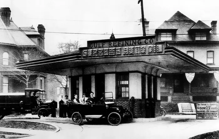 Framed Print : Three men in a highly polished Chalmers touring car wait for service at Supreme Oil Co. the world's first drive-in gas station, Pittsburgh, PA, December 1, 1913
