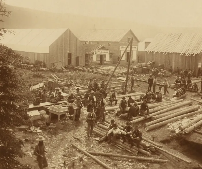 Framed Print : Men, likely out of luck gold seekers, taking a break on a construction site in Dawson City, 1897. The Gold Rush town's population reached 40, 000 in 1898