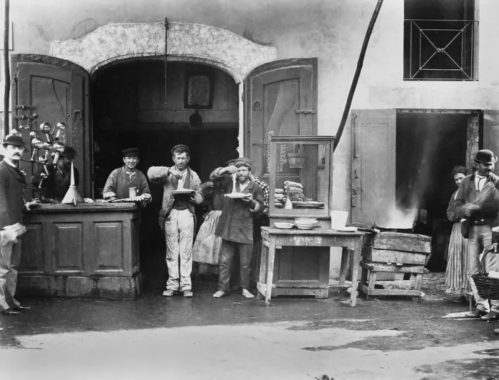 Framed Print : Two men with plates of long spaghetti eat at a street eatery in Naples, Italy. Ca. 1900