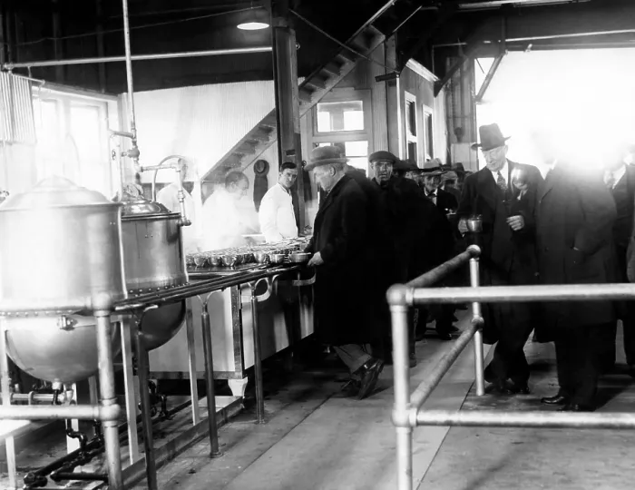 Framed Print : Men wait in line for food at a municipal lodging house. Police Commissioner Edward P. Mulrooney stands with coffee (second from right), New York City, 1930