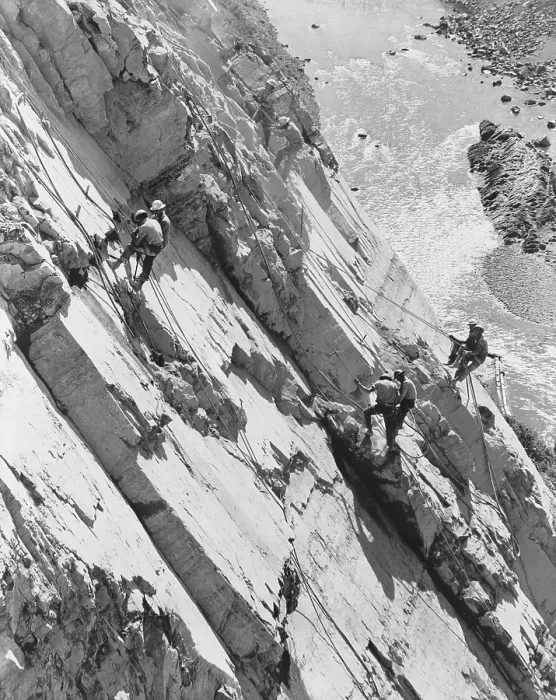 Framed Print : Eight men working high up on rock face of canyon wall, drilling holes for dynamite. They are building Hungry Horse Dam in Montana in 1949. (BSLOC_2014_13_227)