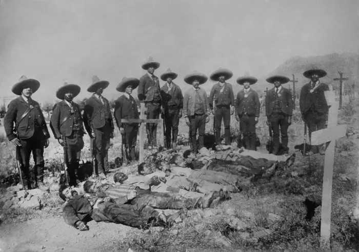 Framed Print : Mexican Rurales, the Federal mounted police, stand over the bodies in a cemetery