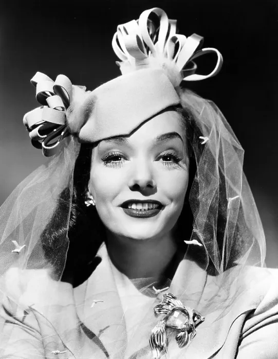 Framed Print : MEXICAN SPITFIRE'S BABY, Lupe Velez, in a beige felt pillbox and a gold brooch set with aquamarine, rubies and diamonds, ph: Ernest A. Bachrach, 1941