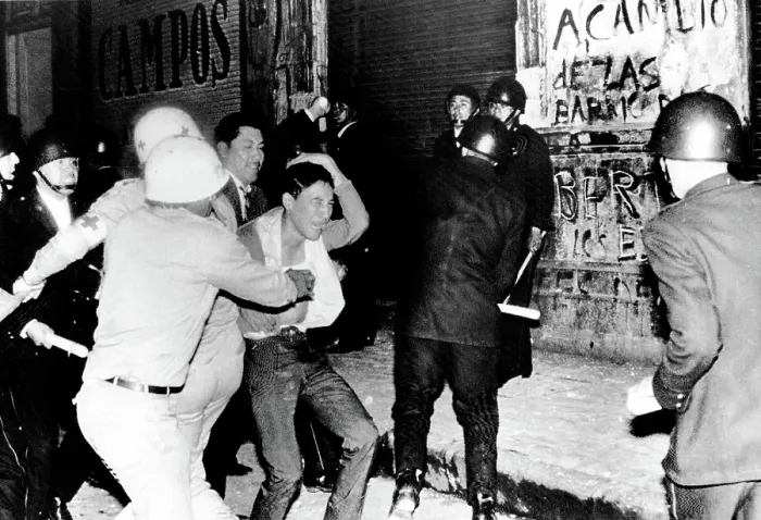 Framed Print : Mexico City: Riot police battle a student demonstrator in a night of violence that ended with Mexican Army troops using bazookas