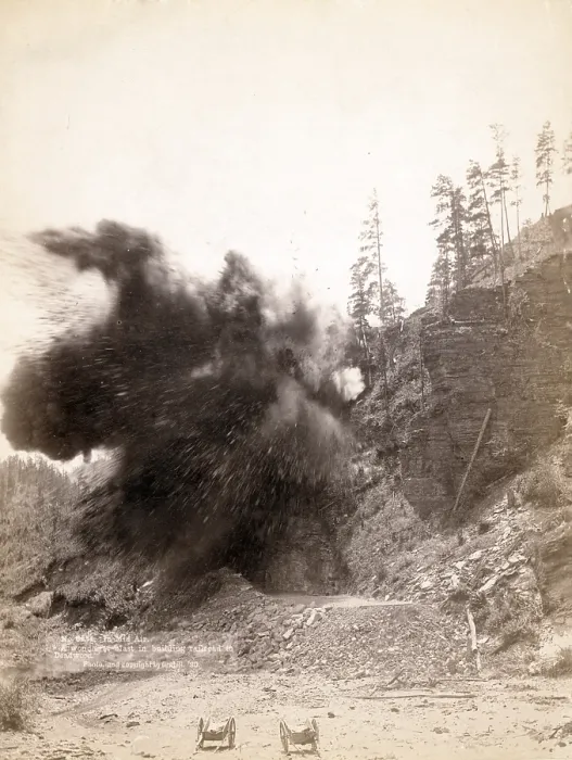 Framed Print : In mid air. A wonderful blast in building railroad to Deadwood. Dakota Territory. photo by John C. Grabill, 1887