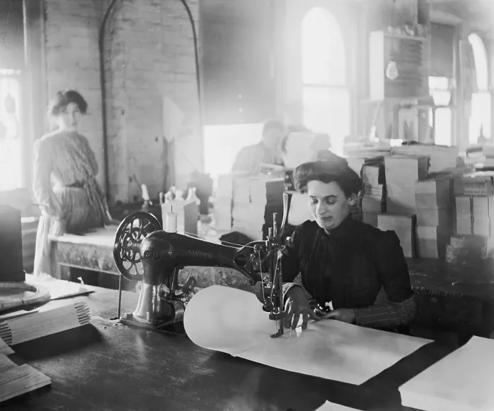 Framed Print : Middle-aged woman sewing on a belt driven Singer machine at the Richmond & Backus Company, Detroit, Michigan, ca. 1905 Framed Print : Middle-aged woman sewing on a belt driven Singer machine at the Richmond & Backus Company, Detroit, Michigan, ca. 1905