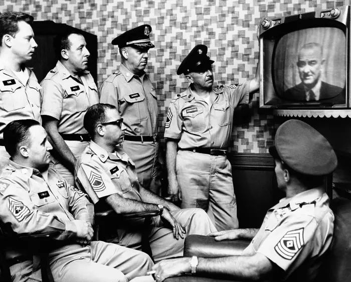 Framed Print : Military men at New York's 71st Street Armory watch President Lyndon Johnson's address on the US build-up in Vietnam. July 28, 1965