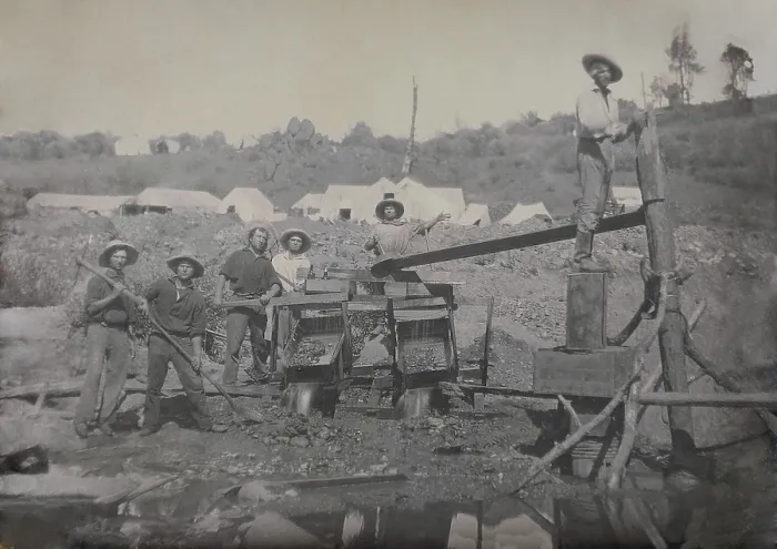 Framed Print : Six miners work with a placer mining apparatus in California in the 1850s. In the background are several tents, likely the miners temporary tent community
