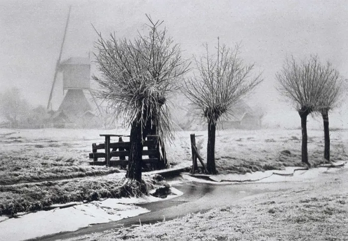 Framed Print : Misty Winterday, by Beers, J.G. 1904, photograph. Dutch foggy winter scene with windmill, pruned trees, snow and partially frozen canal (BSLOC_2016_2_1)