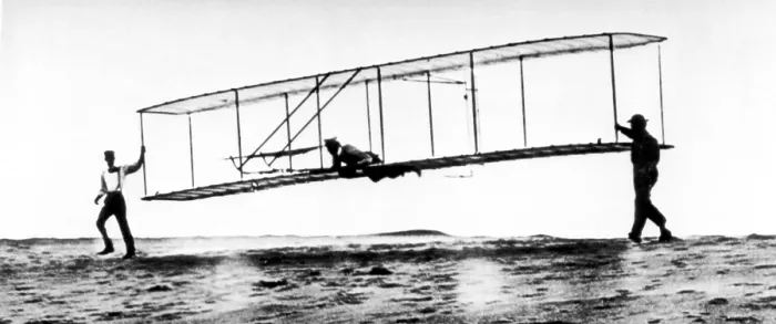 Framed Print : The modified No. 3 Glider (1902) being launched at Kill Devil Hill, with Orville Wright piloting as brother Wilbur helps.. Courtesy: CSU Archives  /  Everett Collection