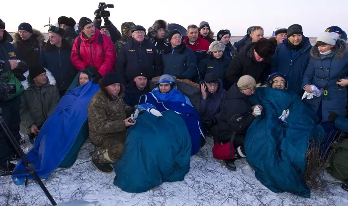 Framed Print : After five months in space, space travelers recline in chairs the Soyuz TMA-02M capsule after they landed in Kazakhstan