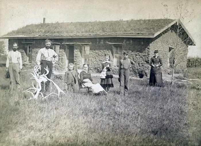Framed Print : Morrison family in front of sod house in Custer County, Nebraska in 1886. Lumber was scare and sod dwellings were the first home for many pioneers