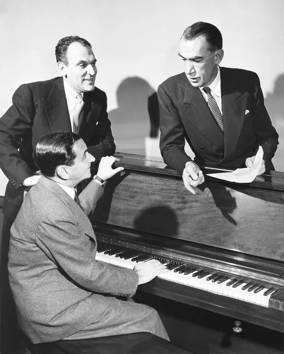 Framed Print : Moss Hart (left), Robert E. Sherwood, and Irving Berlin at the piano. They are collaborating on a new musical, Miss Liberty based on a book by Robert E