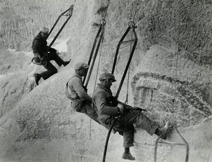Framed Print : Mount Rushmore workers hanging in swing seats, Ca. 1935. They use jackhammers to carve Jefferson's eye as sculptor Gutzon Borglum observes Framed Print : Mount Rushmore workers hanging in swing seats, Ca. 1935. They use jackhammers to carve Jefferson's eye as sculptor Gutzon Borglum observes