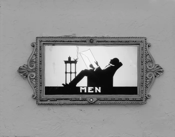 Framed Print : Movie Theaters, restroom door, detail depicting a man reading, from the Ambler Warner Theater, 108 East Butler Pike, Ambler, Pennsylvania, circa 1930s
