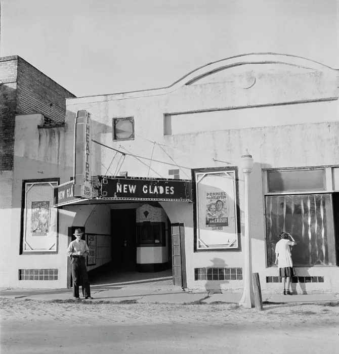 Framed Print : Movie theatre, the New Glades theater, with posters advertising PENNIES FROM HEAVEN, and THE SAINT IN NEW YORK, Moore Haven, Florida, photograph by Marion Post Wolcott, January Framed Print : Movie theatre, the New Glades theater, with posters advertising PENNIES FROM HEAVEN, and THE SAINT IN NEW YORK, Moore Haven, Florida, photograph by Marion Post Wolcott, January