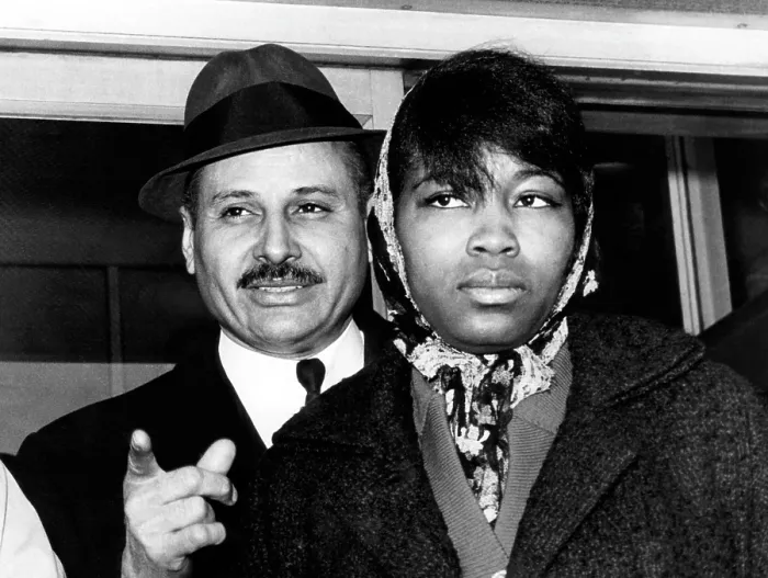 Framed Print : Mrs. Betty Little Shabazz (right), widow of Malcolm X, and her attorney, Percy Sutton, leaving the morgue after identifying the body of her husband. New York, February 22, 1965