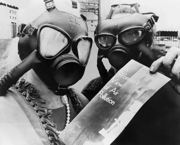 Framed Print : Mrs. Margaret Klein and Mrs. Marvin Blumenfeld, wearing gas masks, as they pass out a health bulletin, A WOMANS VIEW OF AIR POLLUTION at the Kiel Auditorium in St. Louis. 1966