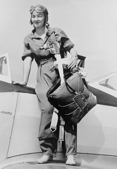 Framed Print : Nancy Harkness Love, wearing the uniform of the Women's Auxiliary Ferrying Squadron. She is standing on a airplane wing with her parachute harness slung over her shoulder