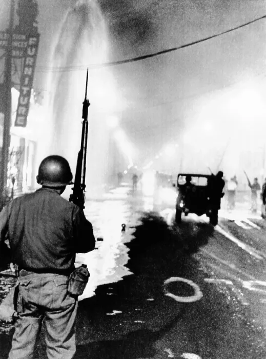 Framed Print : National Guard in Watts during the 1965 race riot. Debris litters the streets and a geyser from broken fire hydrant sprays at left. August 14, 1965 Framed Print : National Guard in Watts during the 1965 race riot. Debris litters the streets and a geyser from broken fire hydrant sprays at left. August 14, 1965