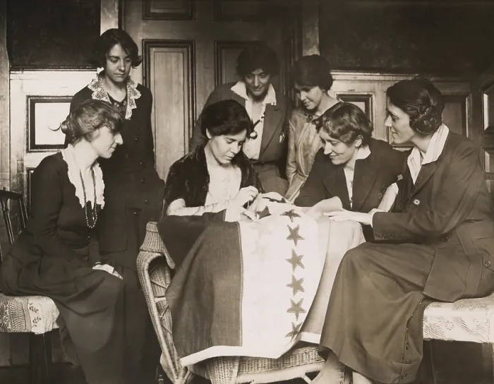 Framed Print : National Woman's Party activists watch Alice Paul sew a star onto the NWP Ratification Flag, representing another state's ratification of the 19th Amendment Framed Print : National Woman's Party activists watch Alice Paul sew a star onto the NWP Ratification Flag, representing another state's ratification of the 19th Amendment