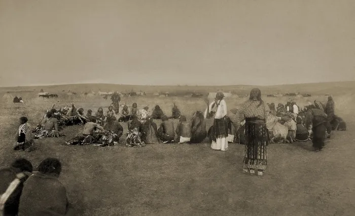 Framed Print : Native Americans performing ritual Ghost Dance c. 1890. One standing woman is wearing a white dress, a special costume for the ritual dance Framed Print : Native Americans performing ritual Ghost Dance c. 1890. One standing woman is wearing a white dress, a special costume for the ritual dance