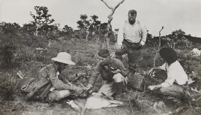 Framed Print : Naturalists of the Smithsonian-Roosevelt African Expedition, squatting around a dead animal. L-R: Kermit Roosevelt, Edmund Heller, Theodore Roosevelt (standing), unidentified