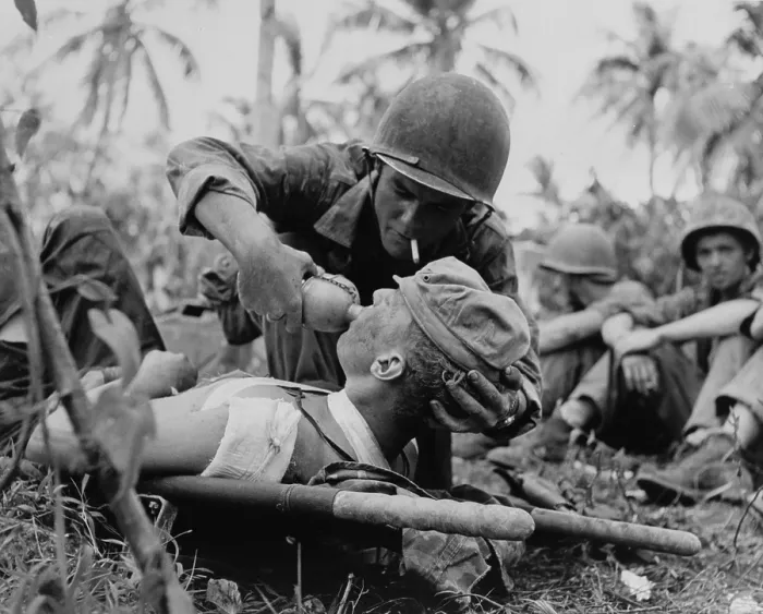 Framed Print : US Navy corpsman gives a drink to wounded Marine on Guam, July 1944, during World War 2. (BSLOC_2017_20_187)