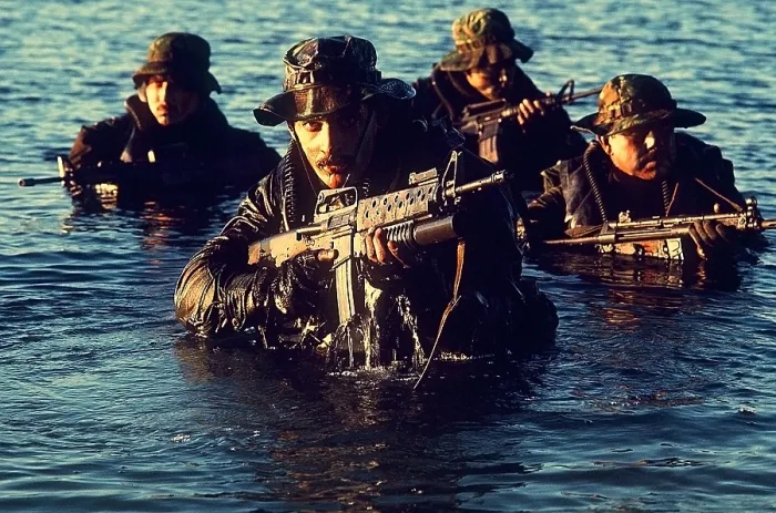 Framed Print : US Navy SEAL team emerges from water during warfare training. Foreground SEAL is armed with an M-16 rifle equipped with a grenade launcher. Dec. 1 1986. (BSLOC_2011_12_275)