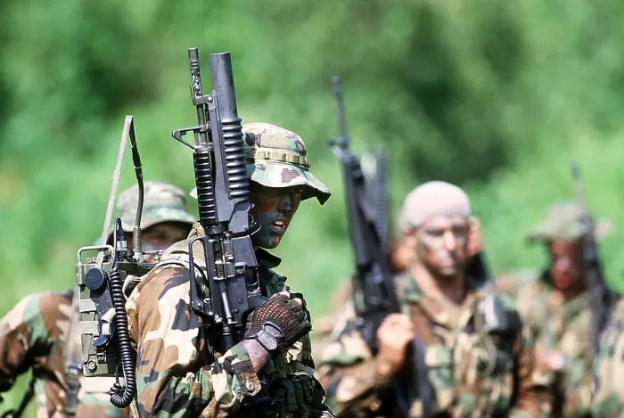 Framed Print : US Navy SEALs in warfare training. Foreground SEAL carries a field radio and a Colt Commando assault rifle equipped with an M-203 grenade launcher. Aug. 1 1987 Framed Print : US Navy SEALs in warfare training. Foreground SEAL carries a field radio and a Colt Commando assault rifle equipped with an M-203 grenade launcher. Aug. 1 1987