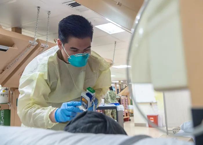 Framed Print : Navy Seaman Luis Librando prepares to take a patient's temperature aboard the USNS Mercy in Los Angeles, April 7, 2020
