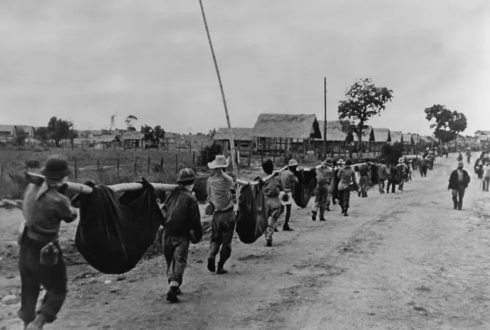 Framed Print : Near end of the Bataan Death March, US prisoners of war carry dead comrades in improvised stretchers of bamboo poles and blankets Framed Print : Near end of the Bataan Death March, US prisoners of war carry dead comrades in improvised stretchers of bamboo poles and blankets