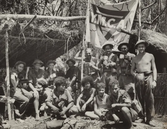 Framed Print : New Guinean natives and Allied troops pause at a YMCA in the jungle
