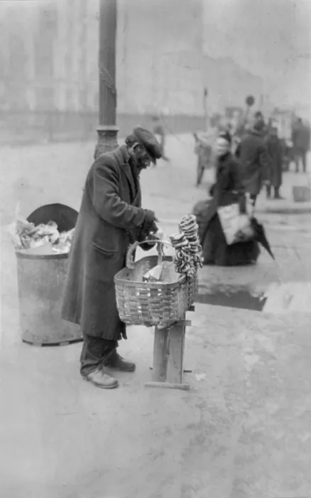 Framed Print : New York City, peddler selling pretzels on sidewalk, East Side food peddler, photograph, February 24, 1917