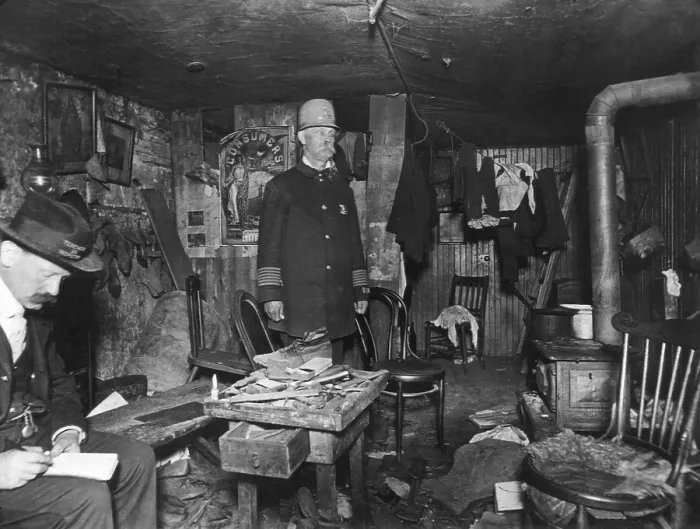 Framed Print : New York City policeman and a housing inspector in a cluttered basement rental c. 1900