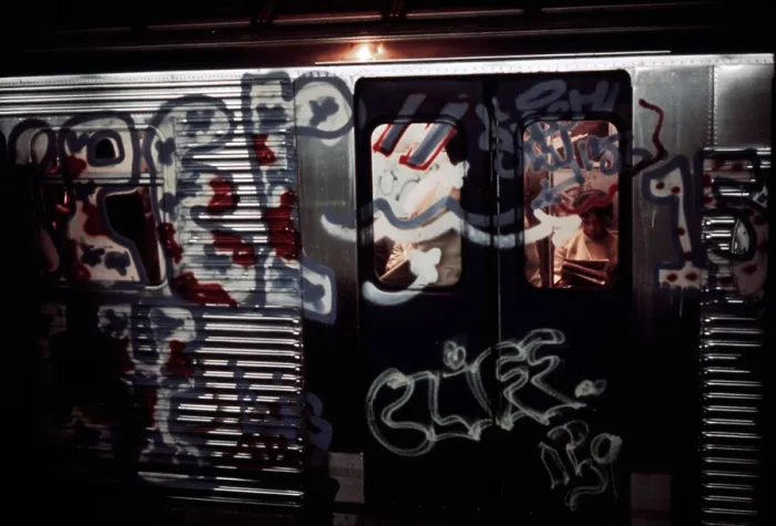 Framed Print : New York City Subway. A subway car with aerosol sprayed paint over in windows and metal of its exterior
