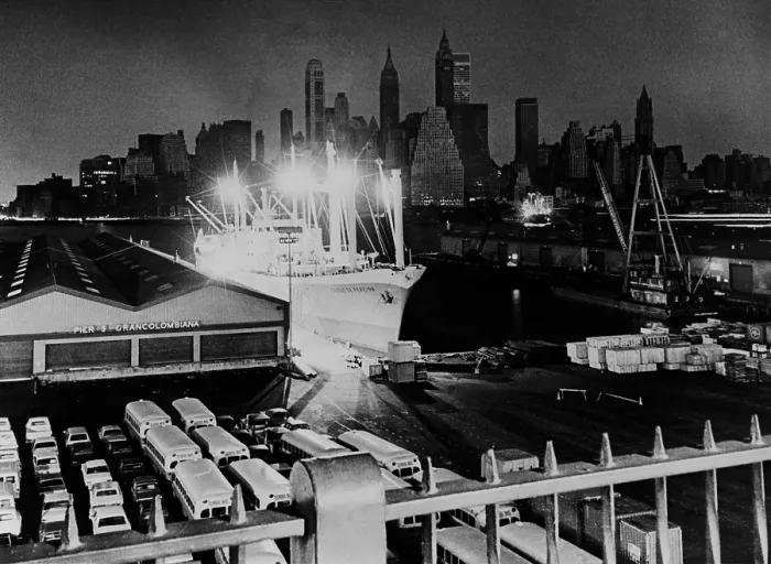 Framed Print : New York City's Manhattan's skyline shrouded in darkness, is offset by the lights of a freighter at a Brooklyn pier Framed Print : New York City's Manhattan's skyline shrouded in darkness, is offset by the lights of a freighter at a Brooklyn pier