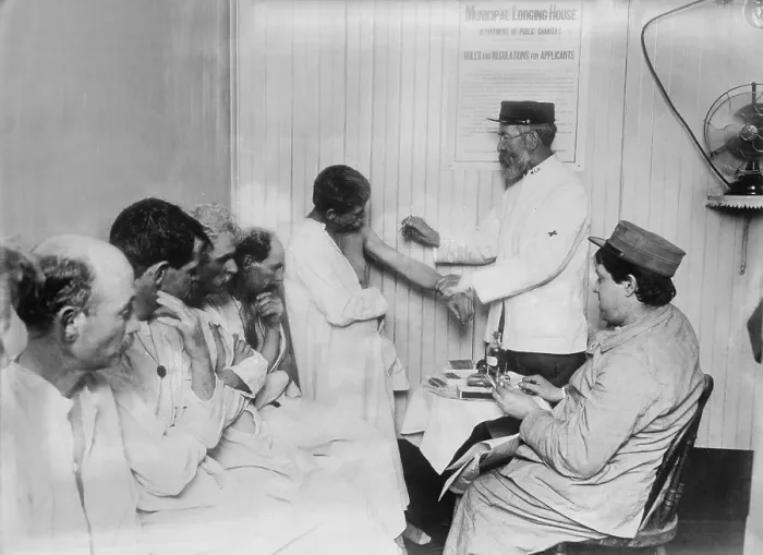 Framed Print : New York City's Municipal Lodging House vaccinated homeless tenants. On the wall is a poster stating the rules of the shelter. 1910 Framed Print : New York City's Municipal Lodging House vaccinated homeless tenants. On the wall is a poster stating the rules of the shelter. 1910
