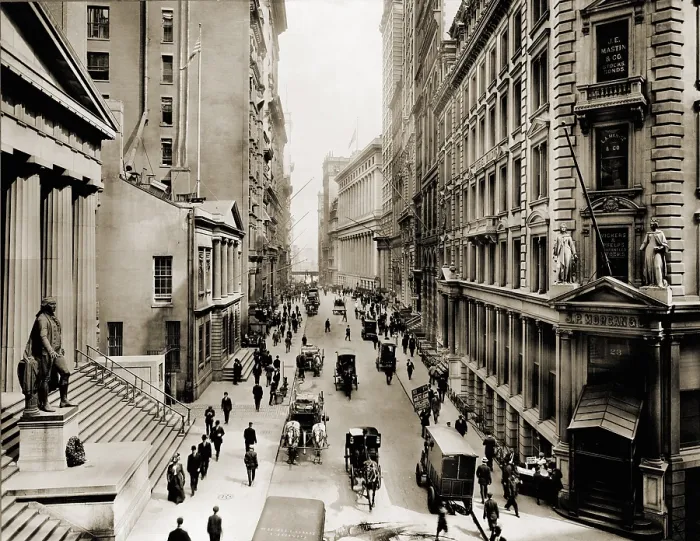 Framed Print : New York City's Wall Street, looking east from the intersection with Broad Street. In foreground left is Federal Hall; on right is J.P. Morgan's bank Framed Print : New York City's Wall Street, looking east from the intersection with Broad Street. In foreground left is Federal Hall; on right is J.P. Morgan's bank