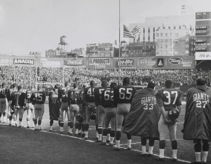 Framed Print : New York Giants football team during a moment of prayer for President John Kennedy. Nov. 24, 1963. The game was well attended, but not telecast