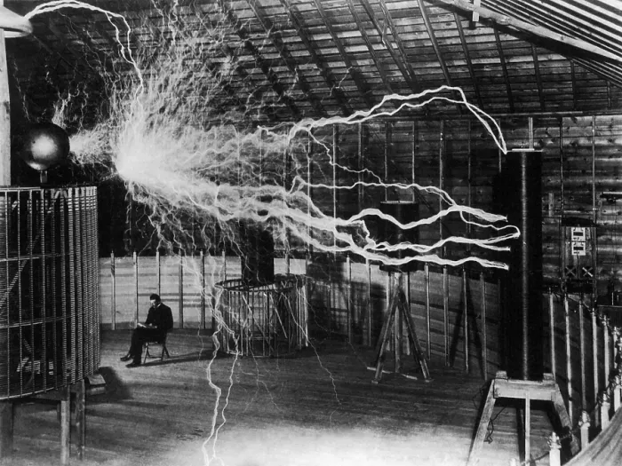 Framed Print : Nikola Tesla 1856-1943 created a double exposure photograph of himself reading undisturbed by a 22 foot long discharge of artificial lightning of millions of volts of electricity Framed Print : Nikola Tesla 1856-1943 created a double exposure photograph of himself reading undisturbed by a 22 foot long discharge of artificial lightning of millions of volts of electricity