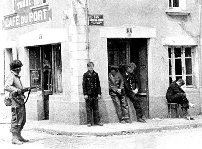 Framed Print : NORMANDY, from Army Signal Corps film, an unidentified American GI stands guard over four Nazis in the streets of Ste. Mere Eglise. Courtesy: CSU Archives  /  Everett Collection